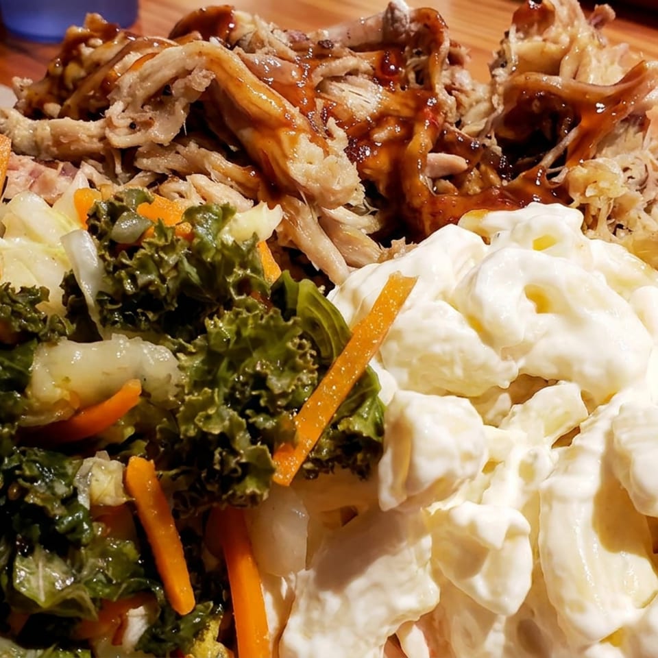 Plate of fried mushrooms with teriyaki sauce, kale and carrot salad, and creamy macaroni salad.
